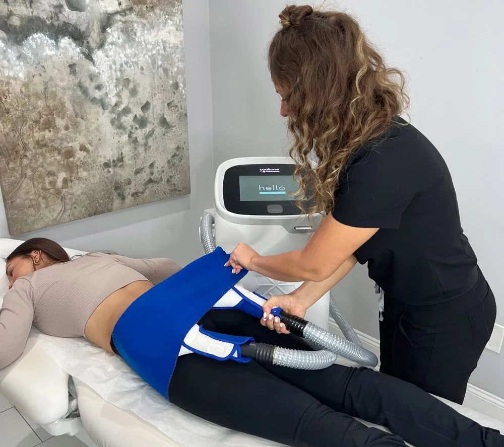 CoolTone body sculpting treatment at Liv Aesthetics LLC in New Fairfield, CT. A client lies relaxed as applicators are positioned on their abdomen, showcasing a non-invasive procedure that tones and strengthens muscles using magnetic muscle stimulation.